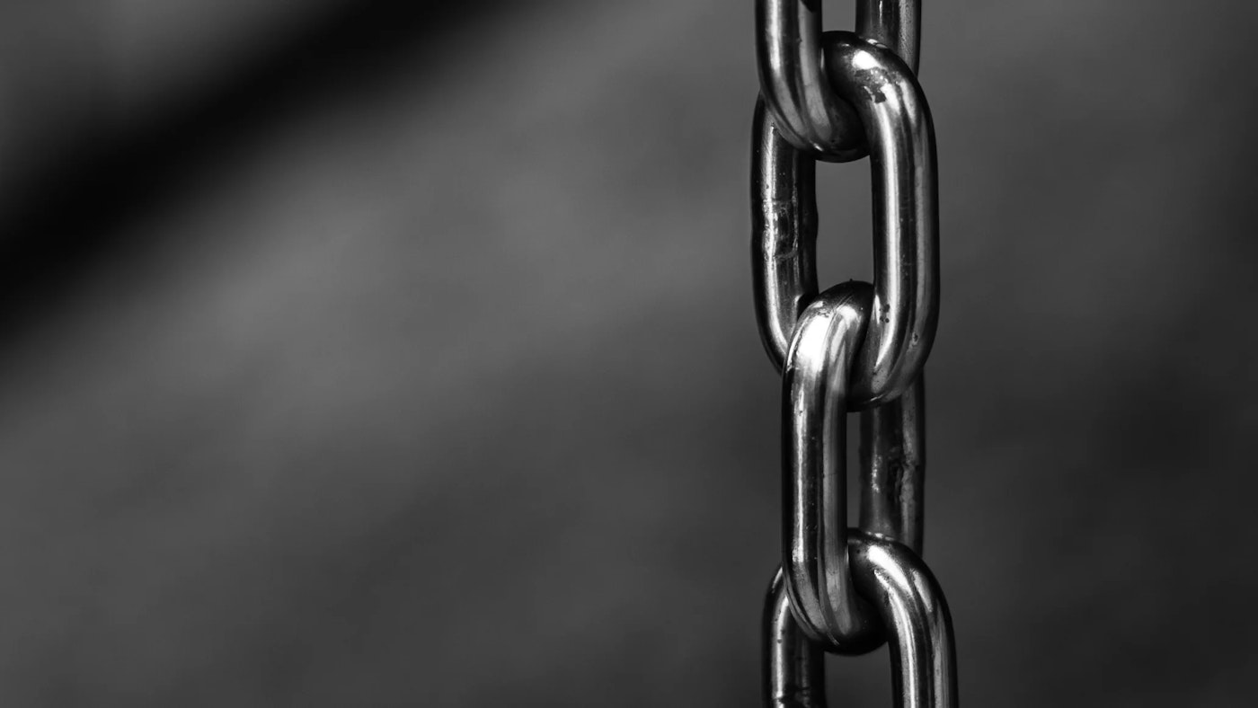 Black and white close-up photo of a chrome chain.