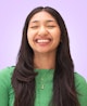 Portrait picture of Yummygum team member Maryam against a light purple backdrop while wearing a green top.
