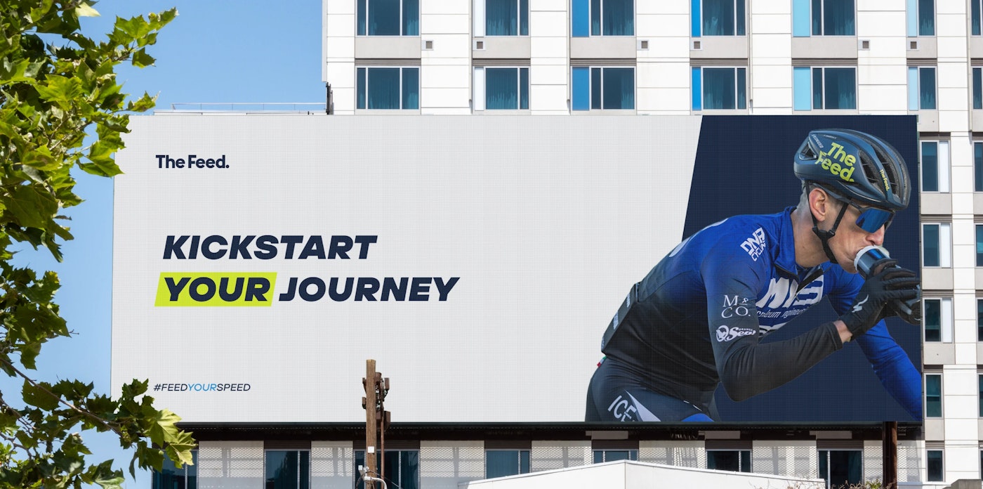 Jumbotron digital billboard that shows the text 'Kickstart your journey' and a photo of the cyclist.