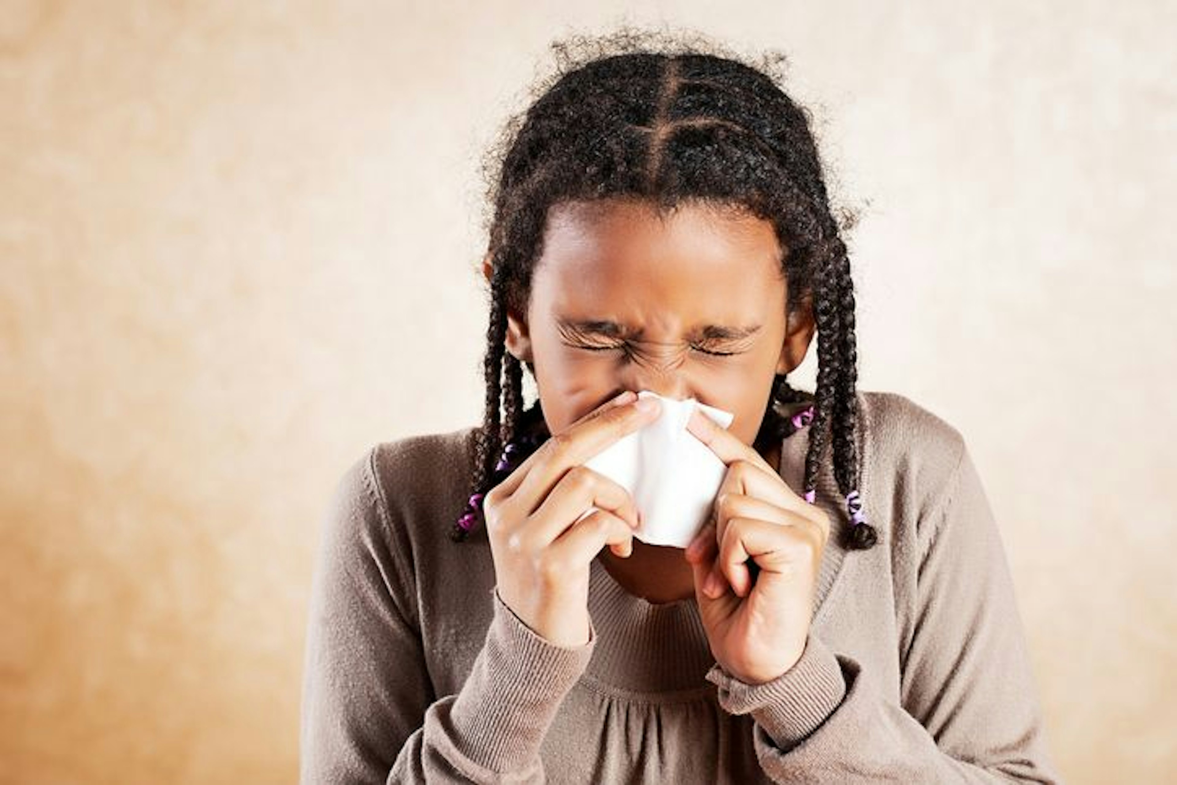 Girl with Allergies blowing nose