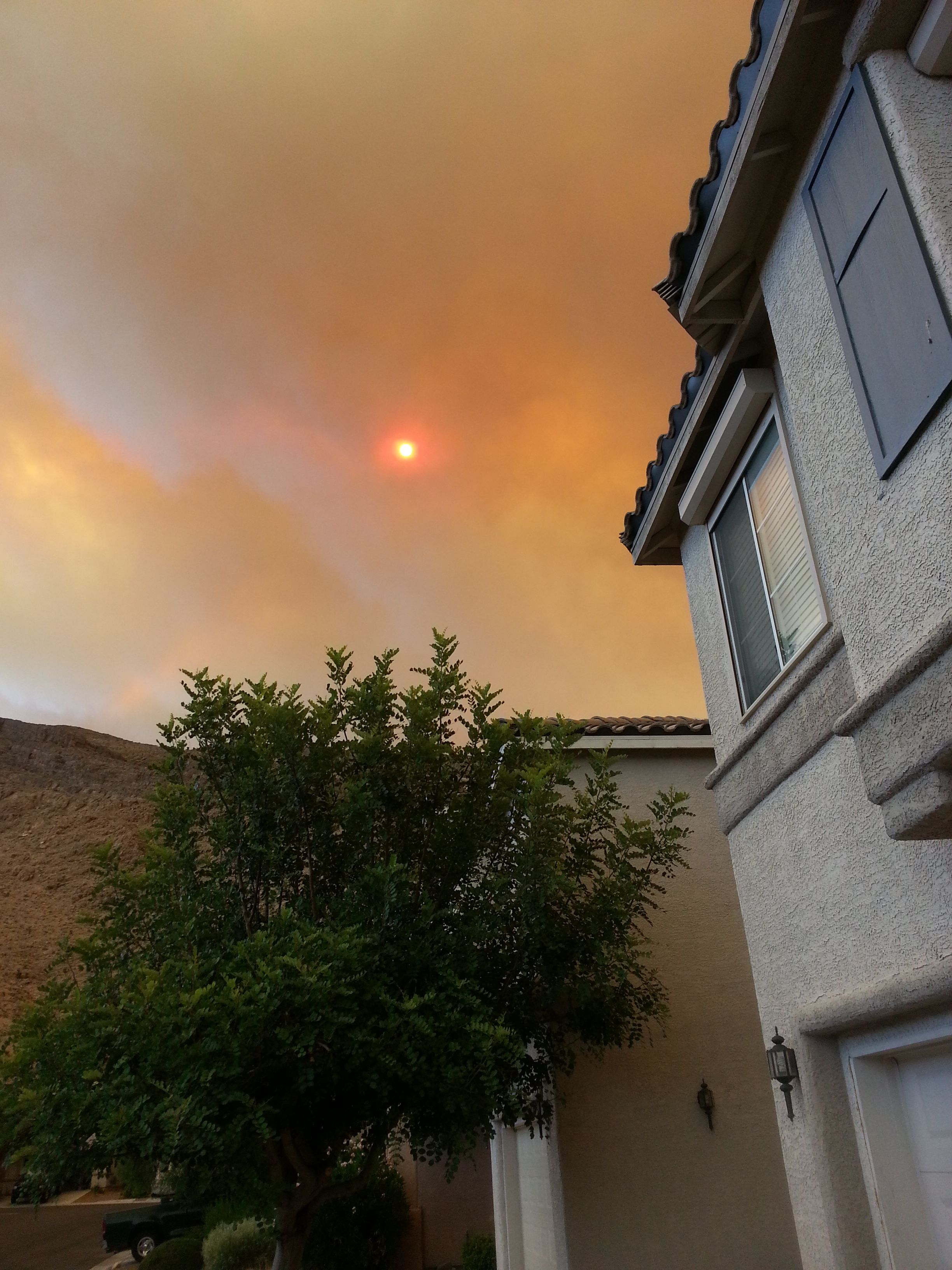 wildfire smoke covering the sky over a residence