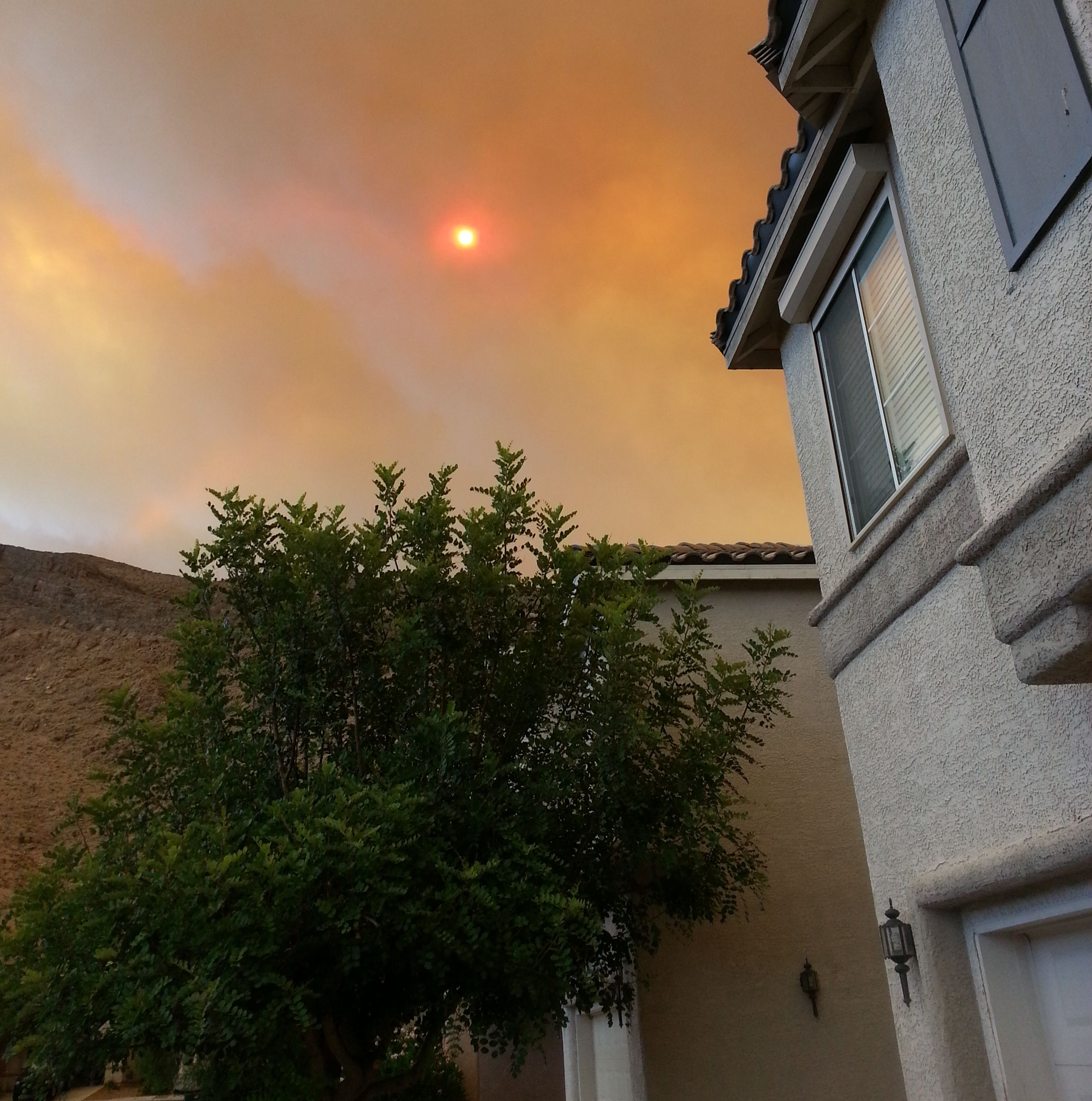 Wildfire smoke covering the sky over residence