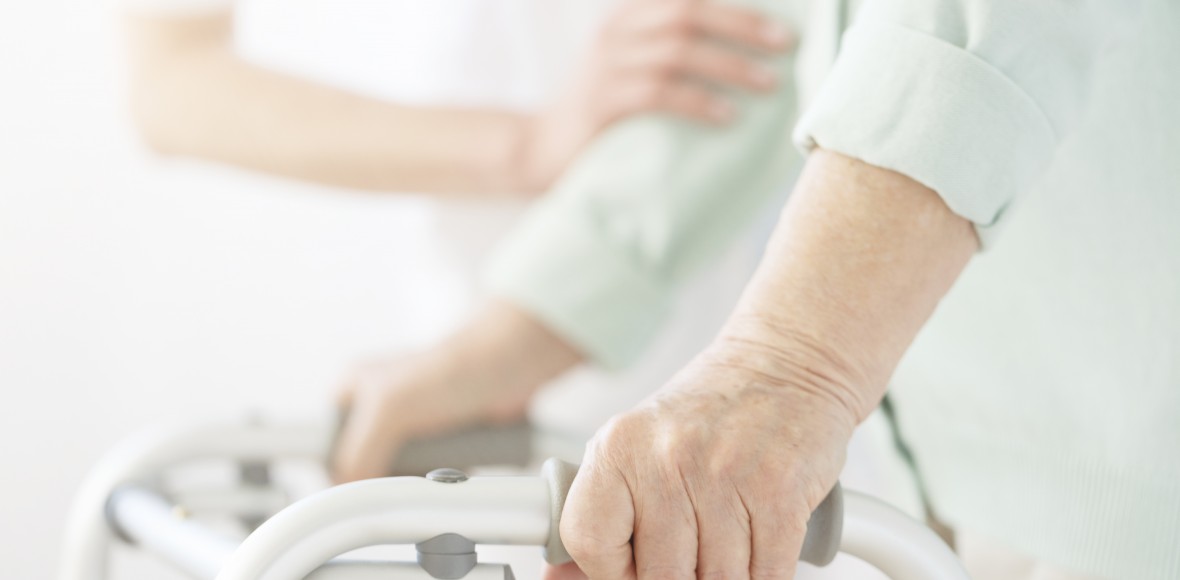 Nurse supporting elderly person
