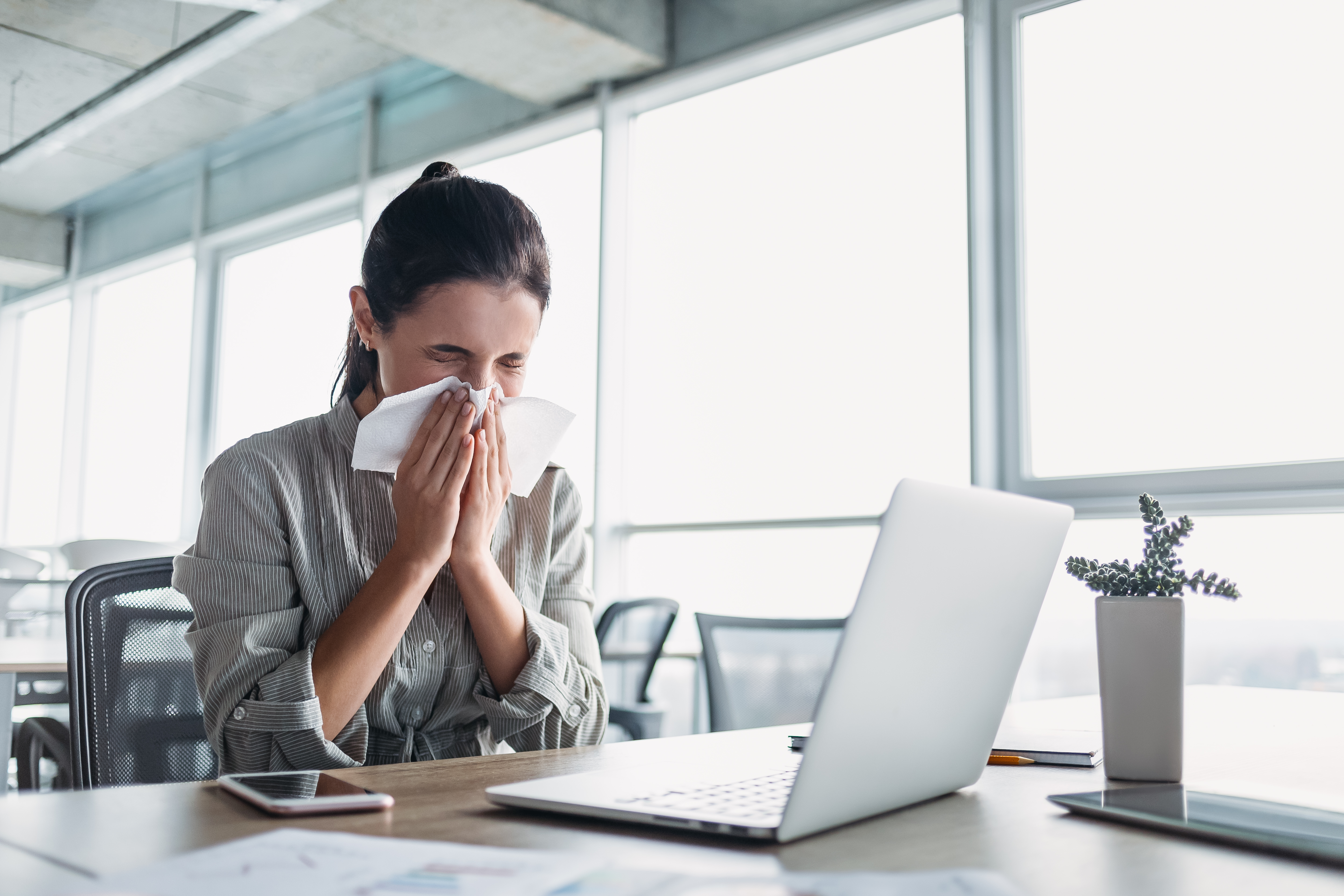 Woman in office with allergies