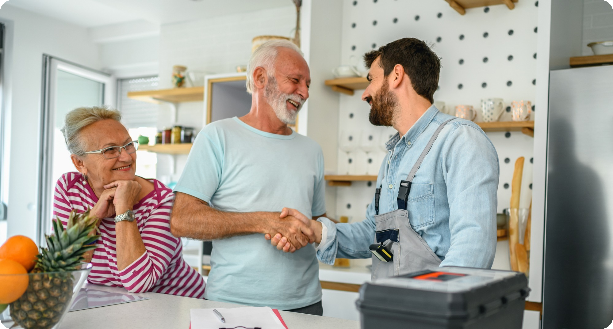 1787876380 contractor talking to happy elderly couple rounded