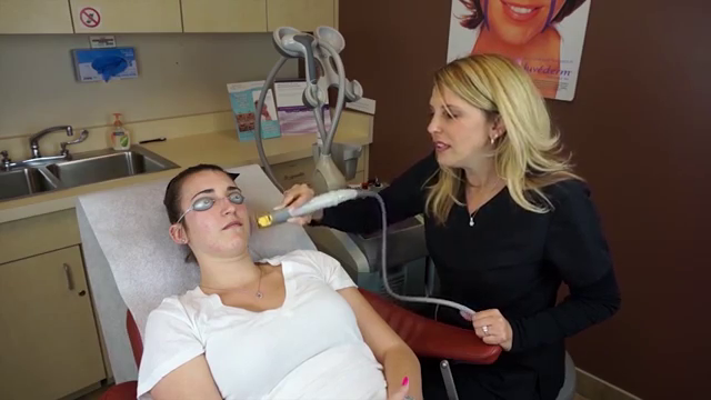 patient laying down in chair receiving a laser treatment