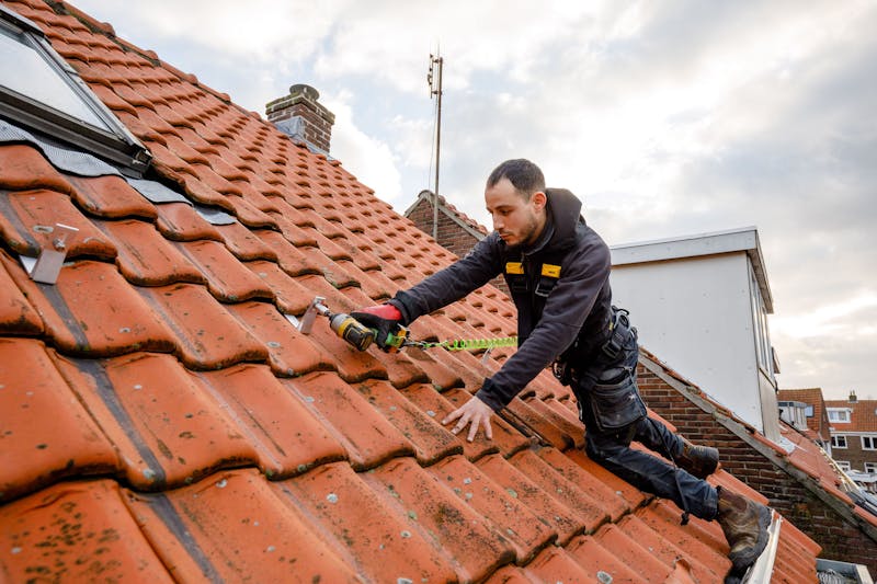 Zonnepanelen installateur op dak