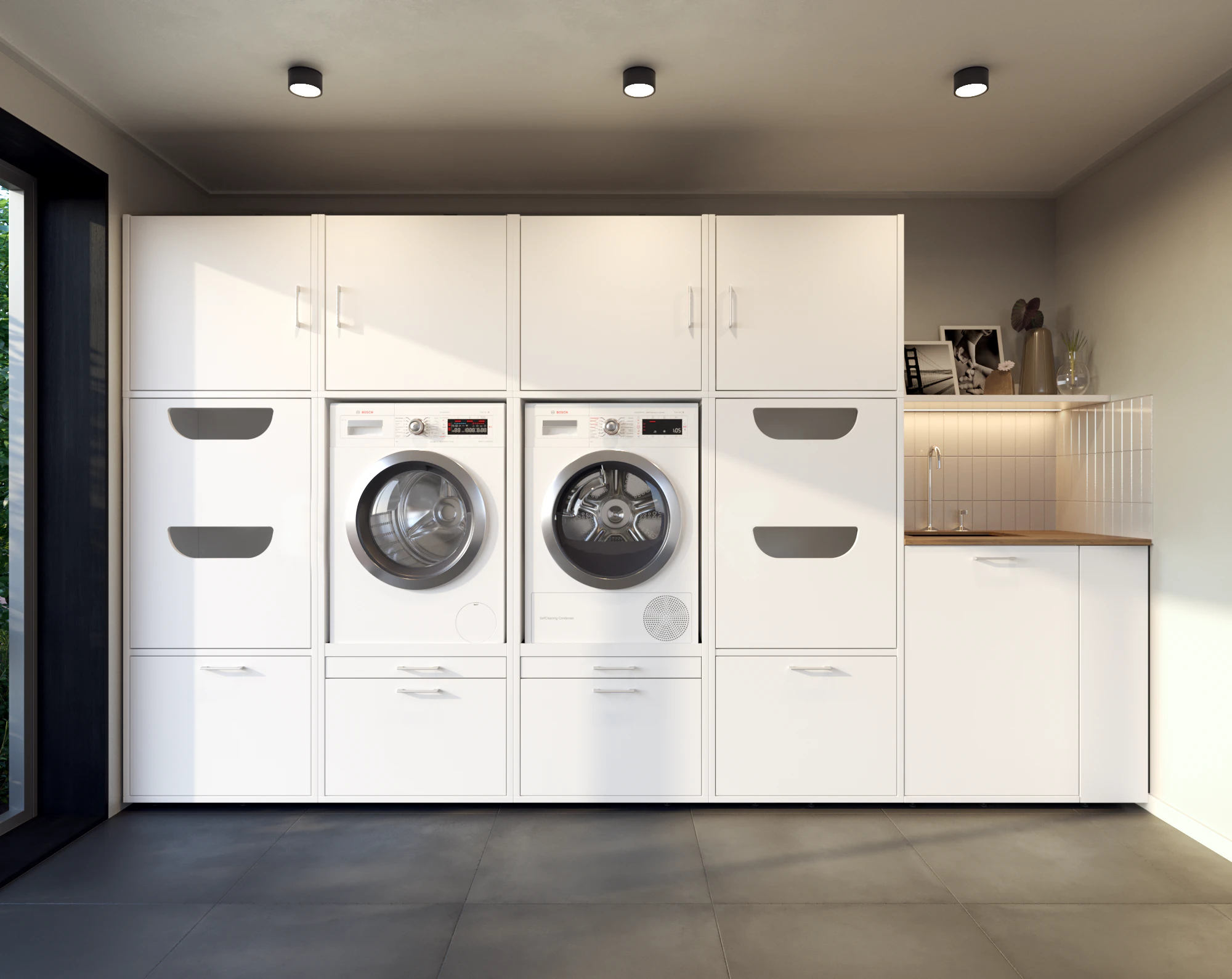 Lifestyle picture of white washing machine and dryer cupboard wall with laundry basket cabinets