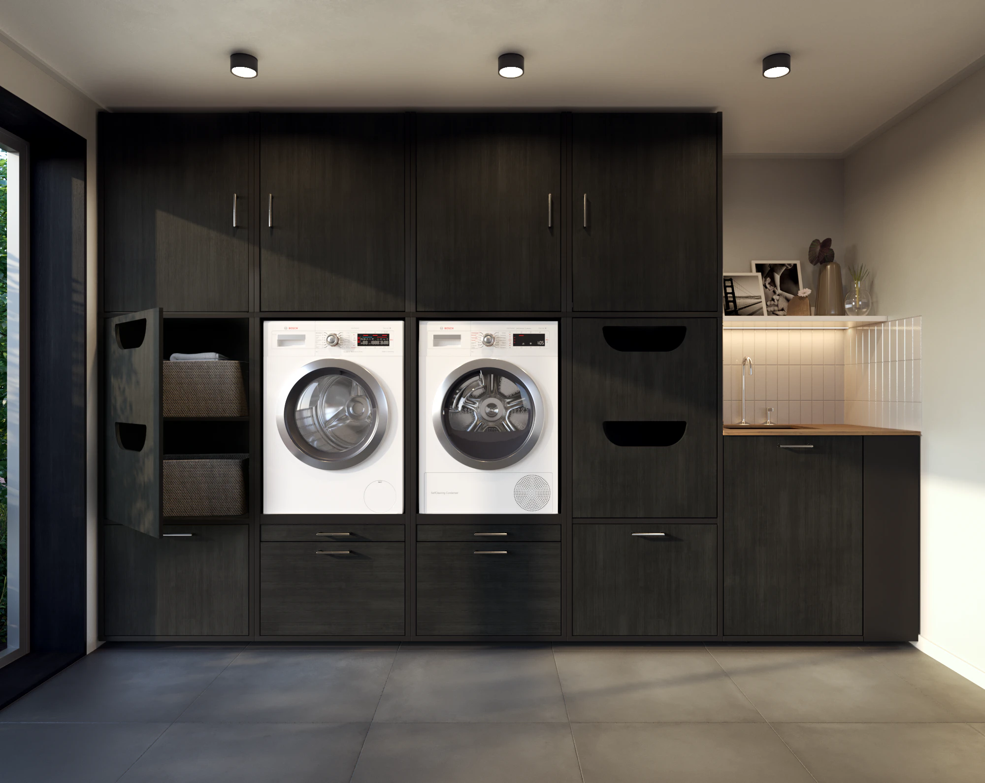Lifestyle black washing machine and dryer wall cupboard with open laundry basket cabinet in scullery