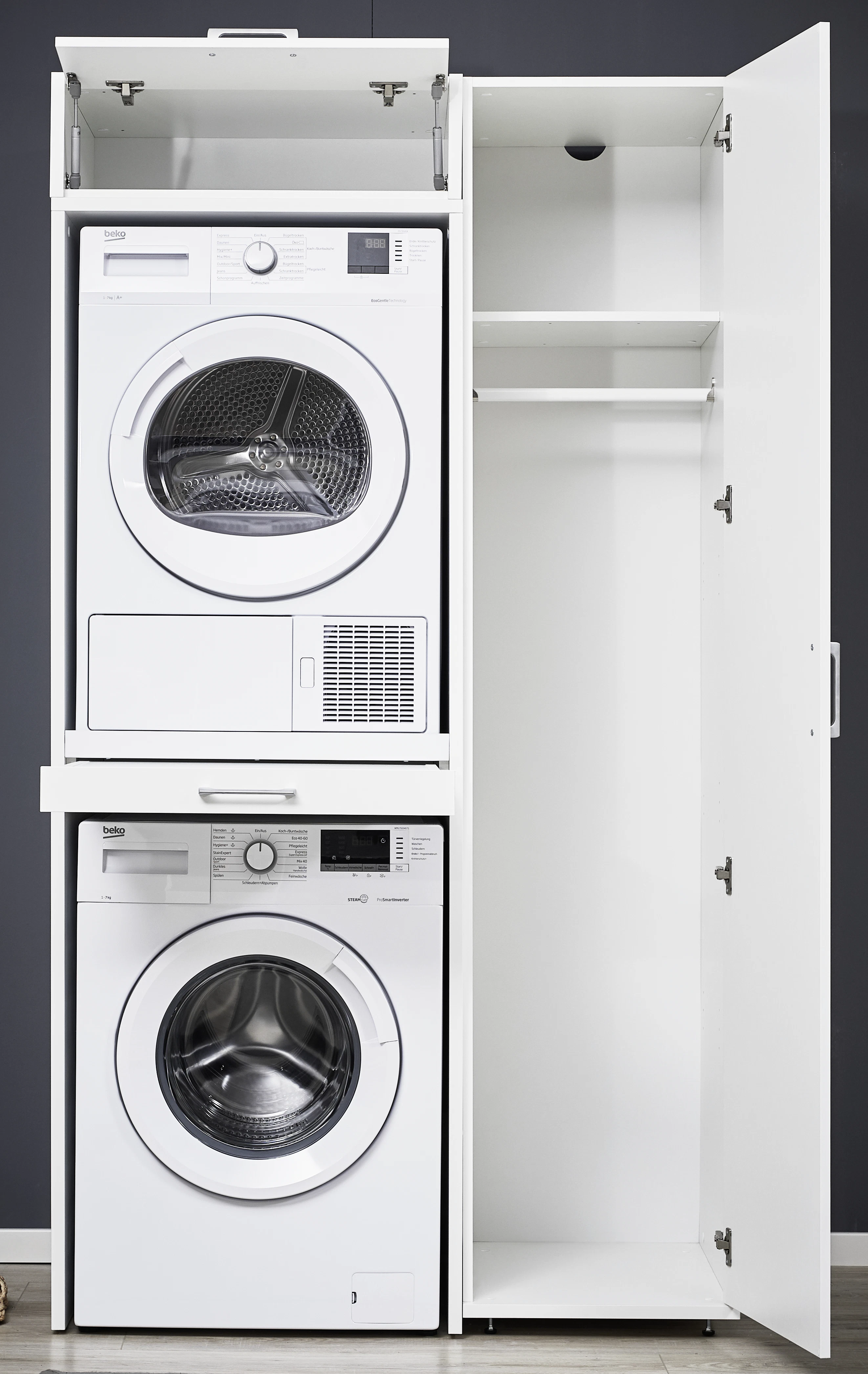 White washing machine and dryer tower wall with open cabinet doors