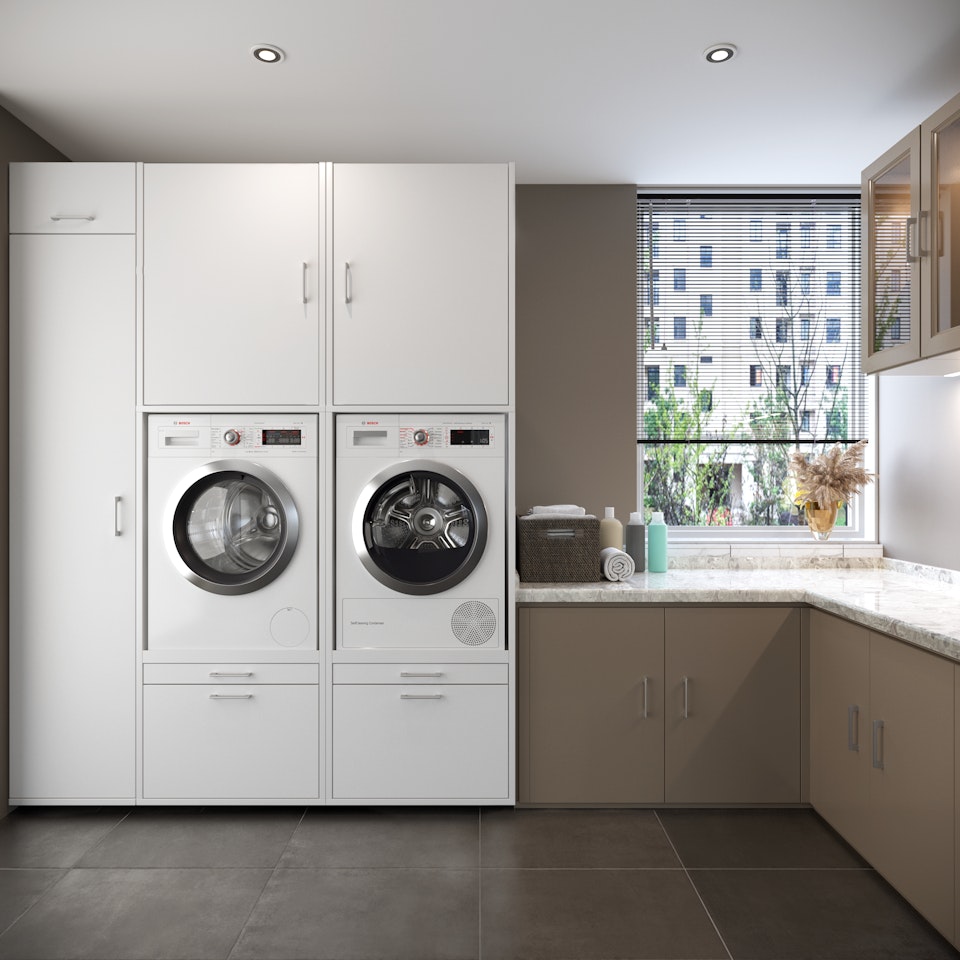 voorbeeld bijkeuken in hoekopstelling met keukenblok en witte kast voor de wasmachine en dorger