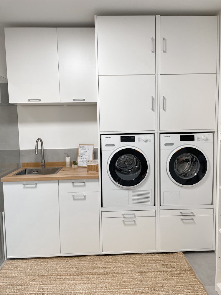 Washtower A tall cupboard for your washer and dryer maximizes vertical space, freeing up room for other kitchen or utility room additions.
