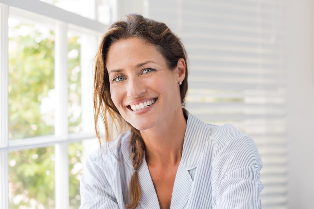 Women Sitting In A House With A Big Warm Smile