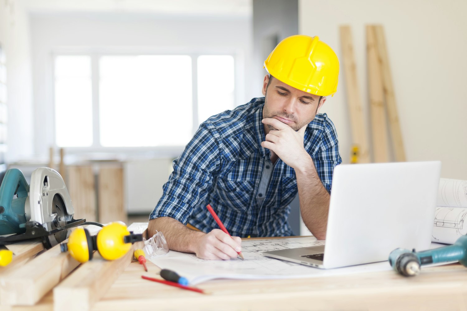 A worker at construction site with his pc 