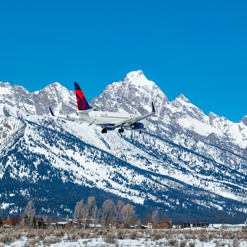 airplane in front of the tetons