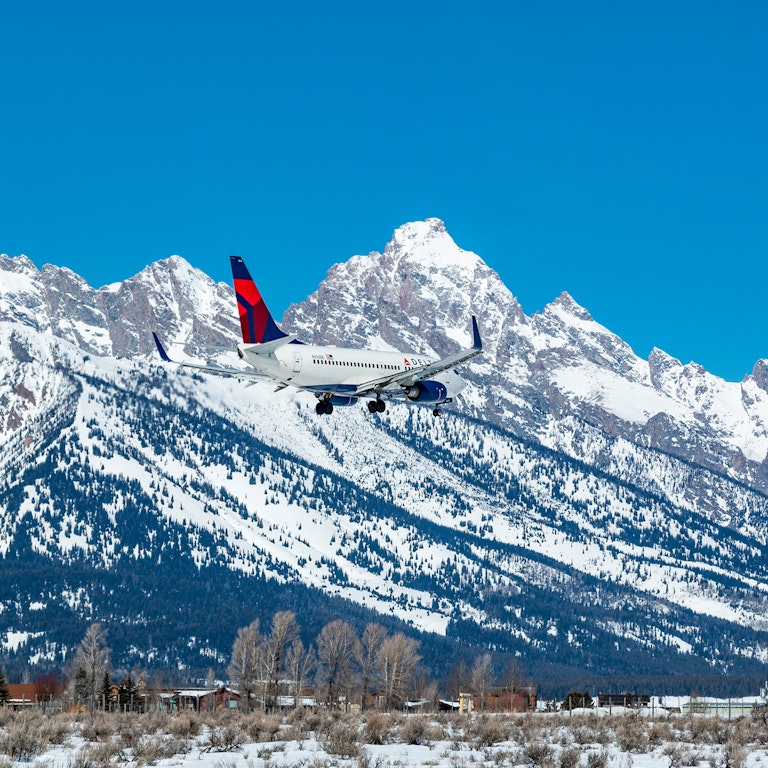 airplane in front of the tetons