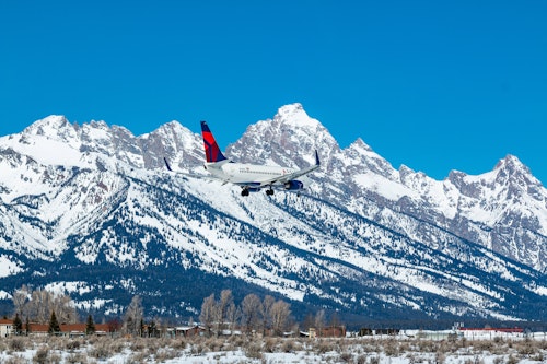 airplane in front of the tetons