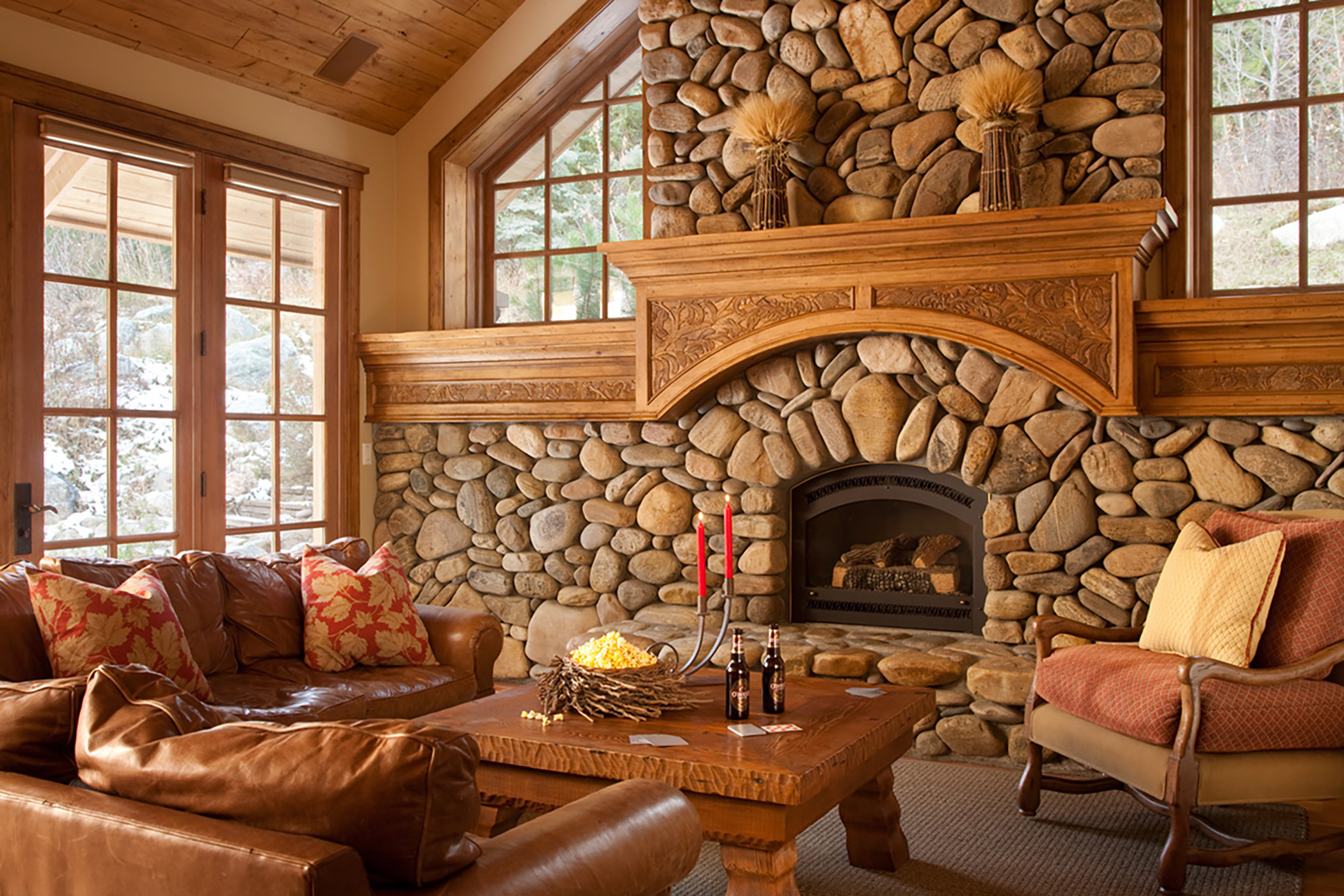 Rustic living room with large stone fireplace