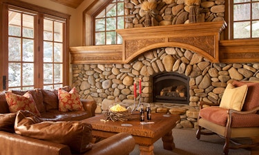 Rustic living room with large stone fireplace