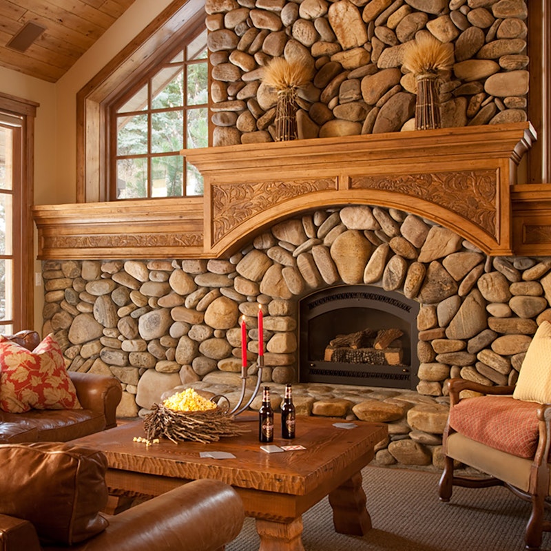 Rustic living room with large stone fireplace