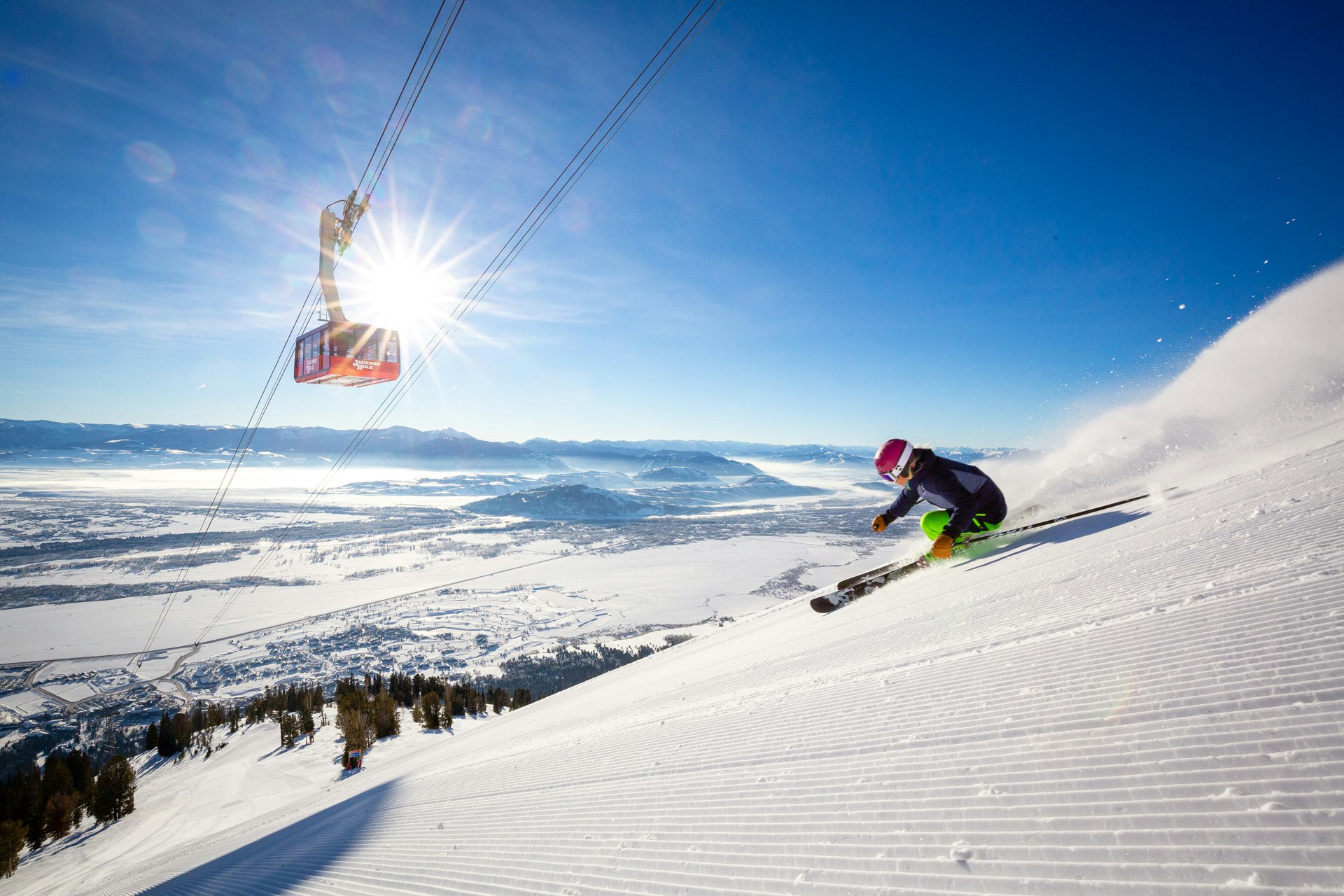 Skiing on a sunny day with the Aerial Tram in the background