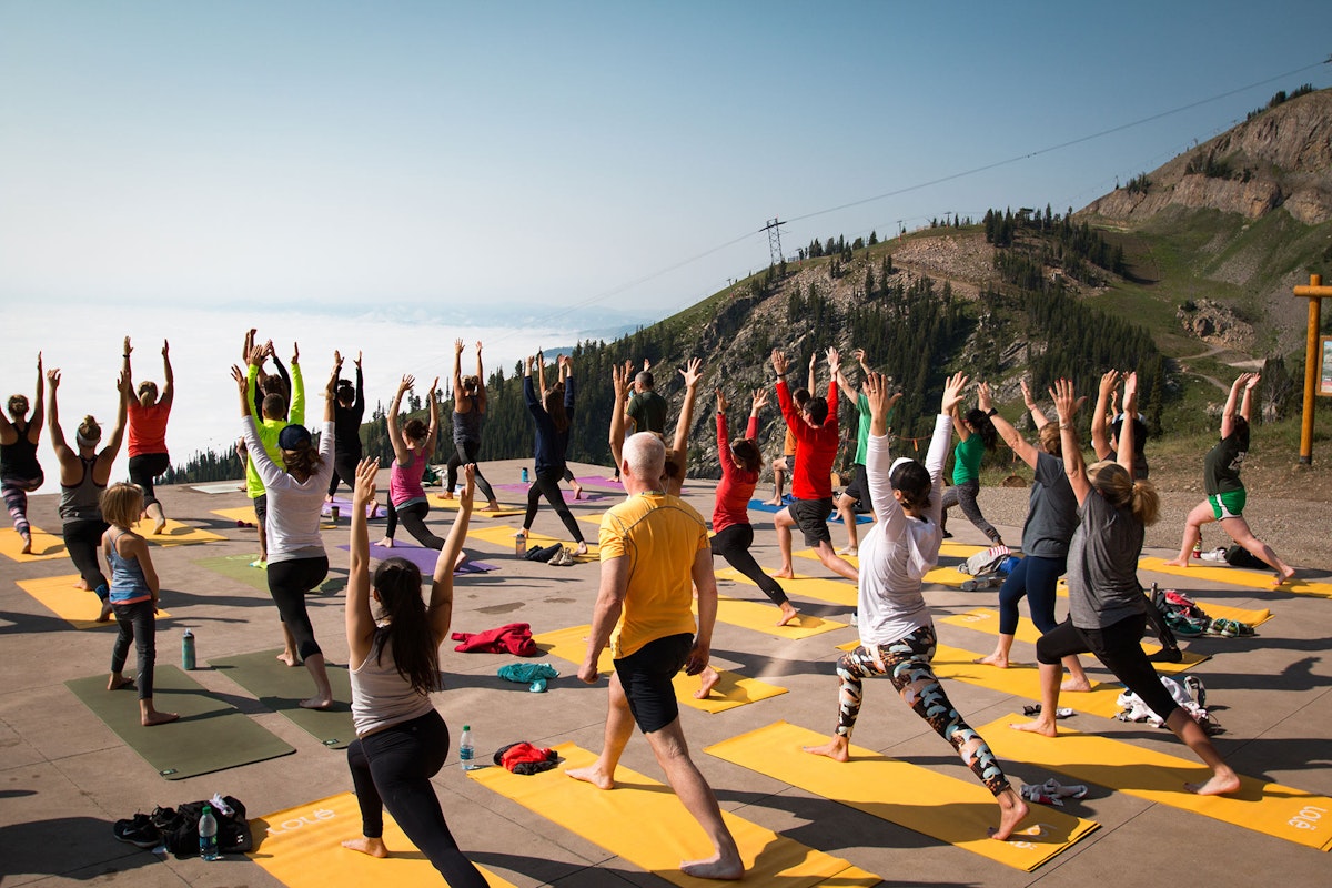 Group relaxing while doing yoga on the Deck with a scenic view