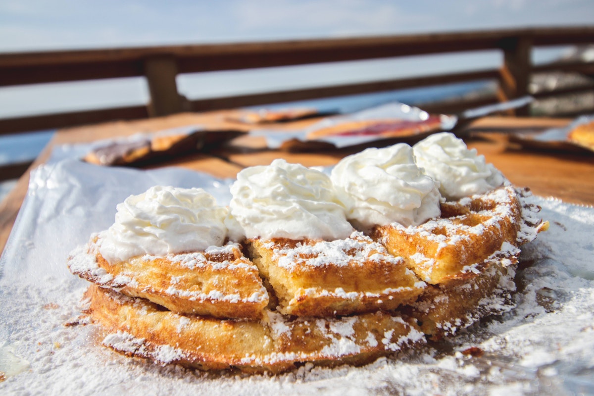 Waffles with powdered sugar and whipped cream
