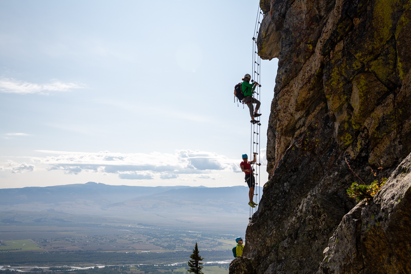 People climbing up the mountain in the Via Ferrata experience.