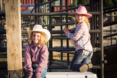 Two children in cowboy hats at the JH Rodeo