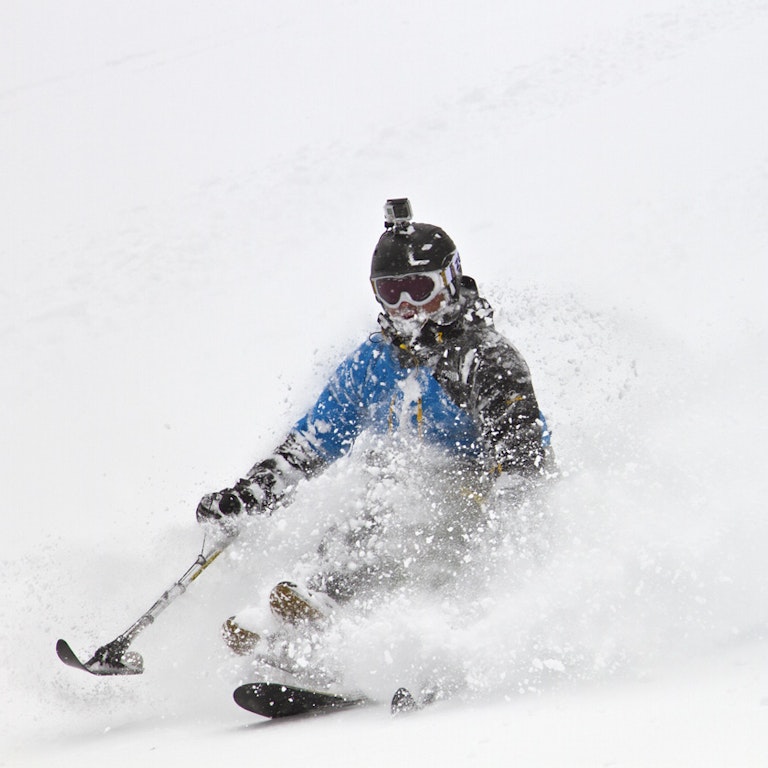 Adaptive skier in deep powder