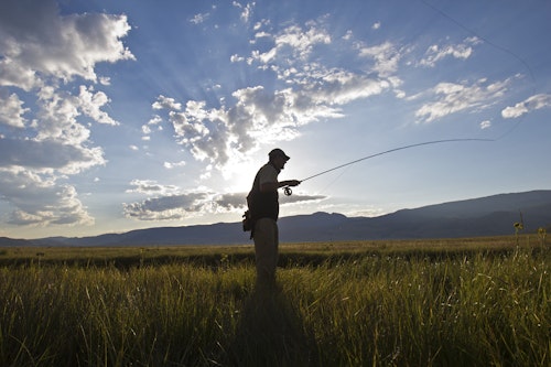 Man fly fishing on a beautiful sunny day