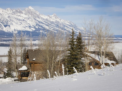 Snowy cabin with Tetons in the background