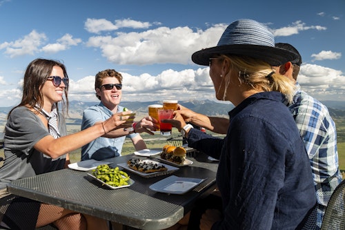 Group having cocktails on the Deck at Piste