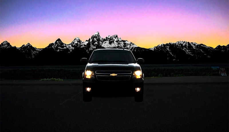 Parked taxi car with the Tetons in the background at sunset