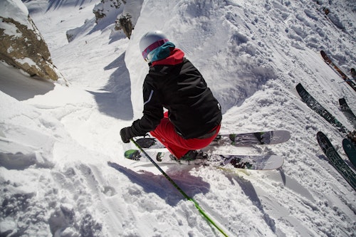 Skier dropping into Corbet's Couloir on a powder day