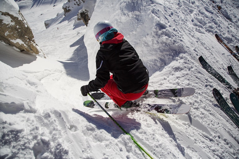 Skier dropping into Corbet's Couloir on a powder day