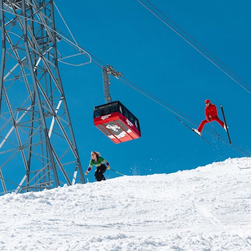 Retro themed skiing underneath the Tram