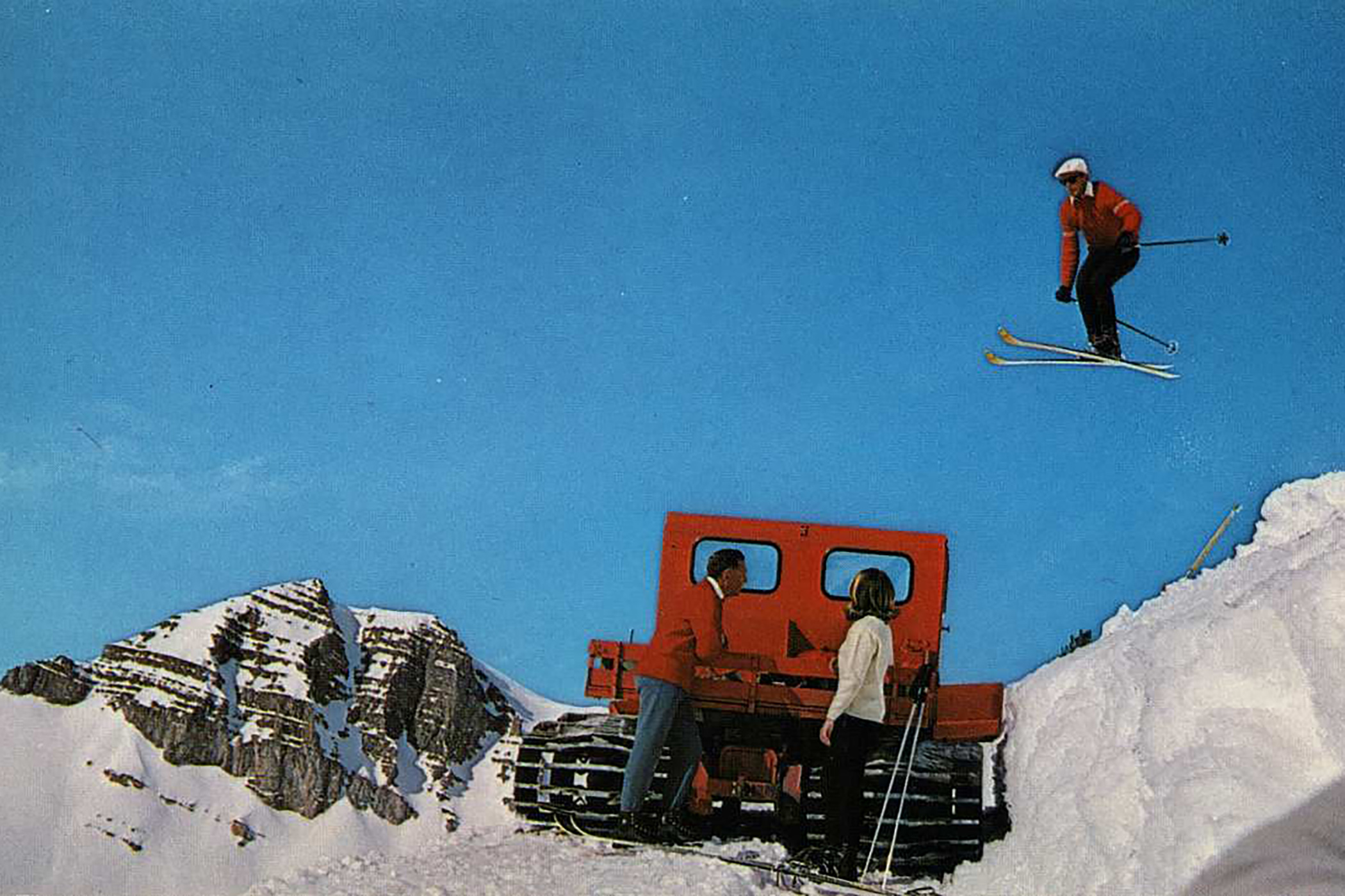 Pepi jumping over a snow cat