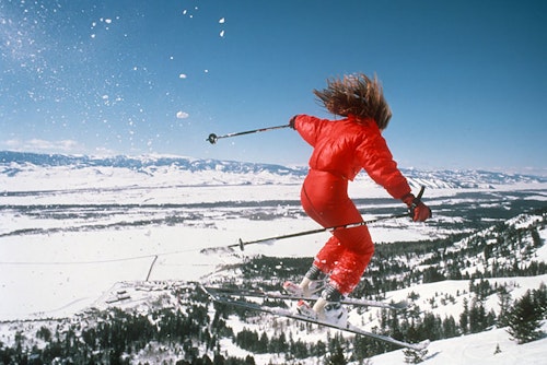 Female skier getting air in the seventies