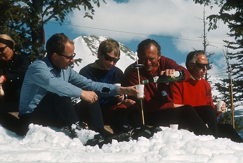 Lifestyle shot of a group pouring a glass of beer in the sixties on the resort