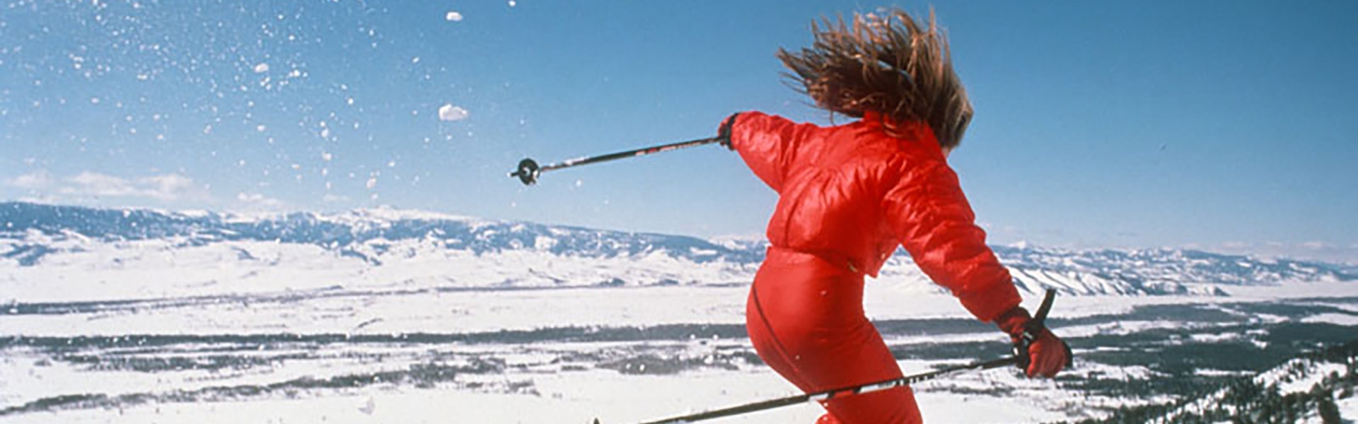 Woman jumping on skinny skis in the 80s