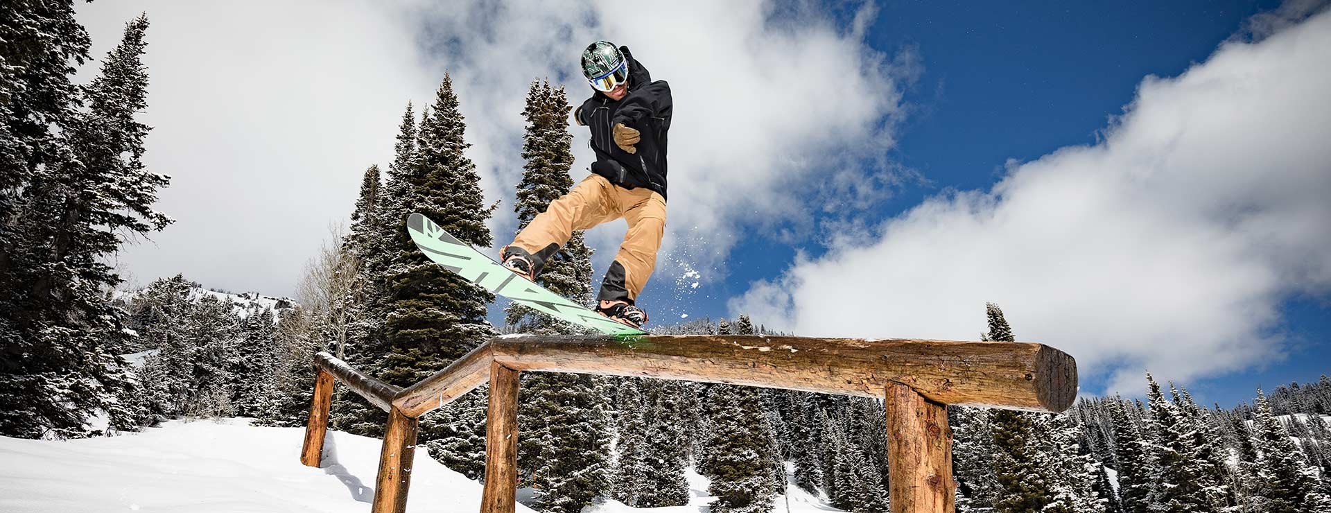 Snowboarder riding a rail in the terrain park