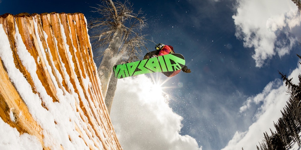 Snowboarder doing a wall ride