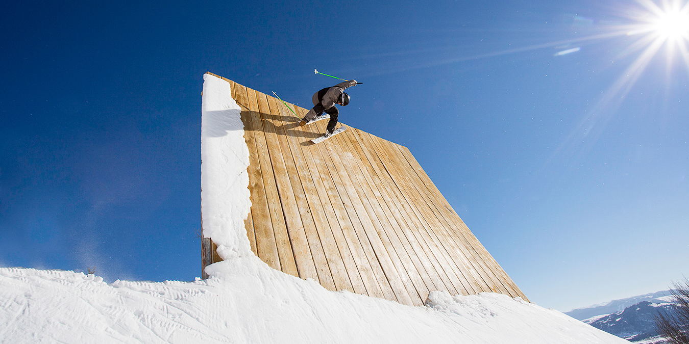 Skier going off of wall in the Stash Park