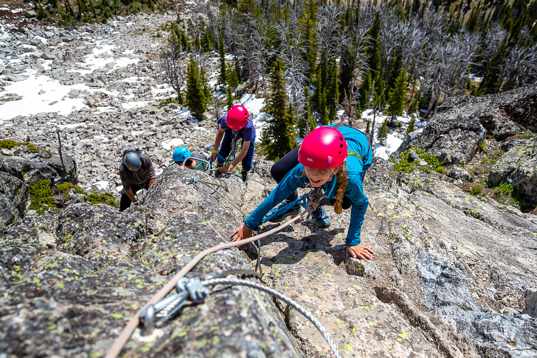 Young girl climbing up the Via Ferrata