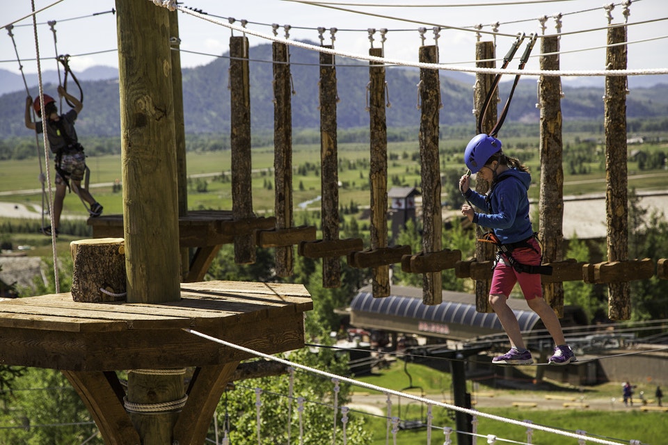Young girl through the aerial adventure course