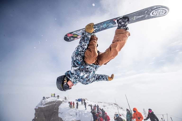 Kings and Queens athlete grabbing snowboard