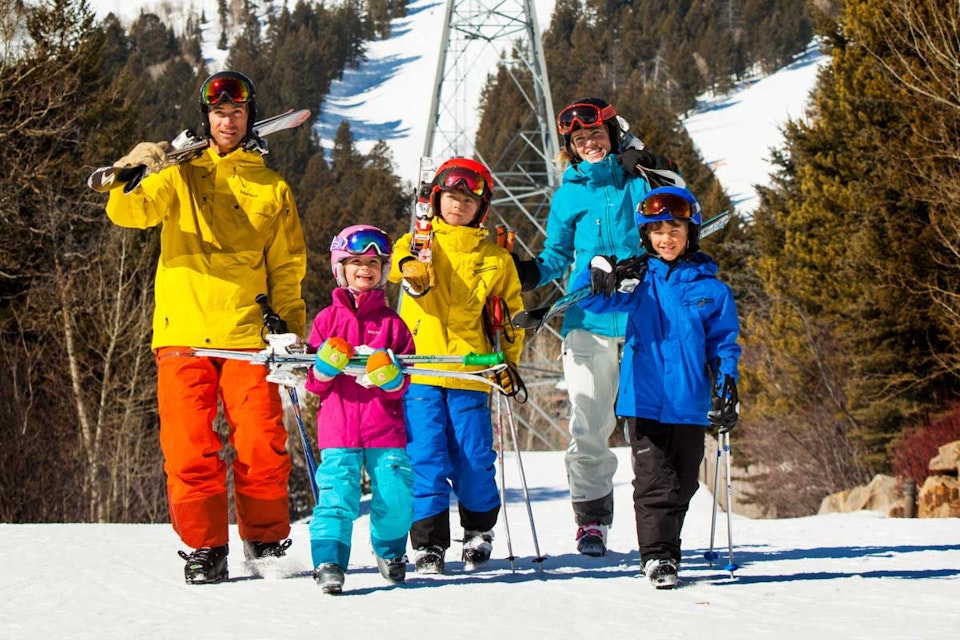 Family walking with Skis in hand