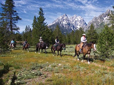 Group on a trail ride with the Grand in the background