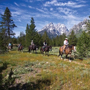 Group on a trail ride with the Grand in the background